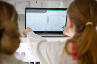 People in front of a laptop
